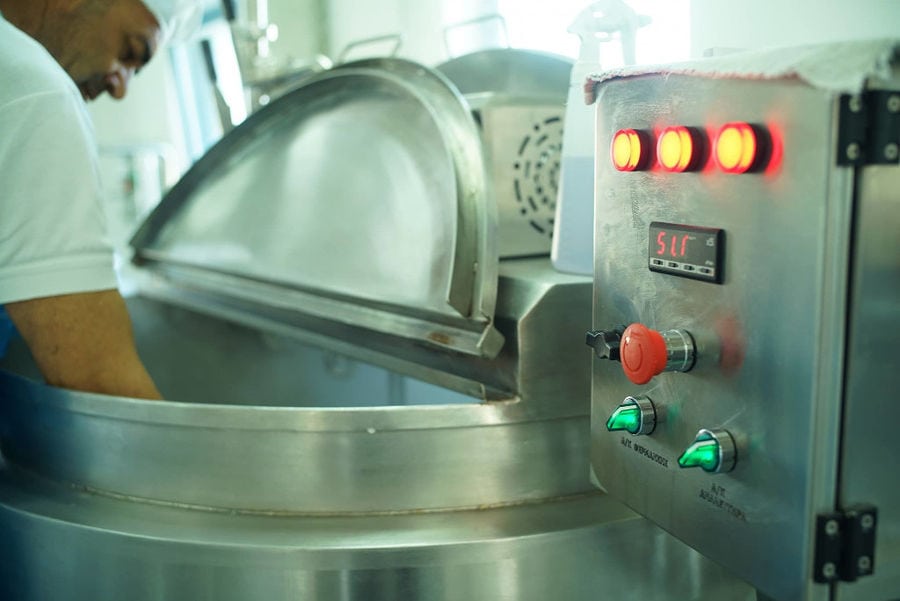 man working dairy aluminum mixer machine at 'Mykonos Farmers' plant